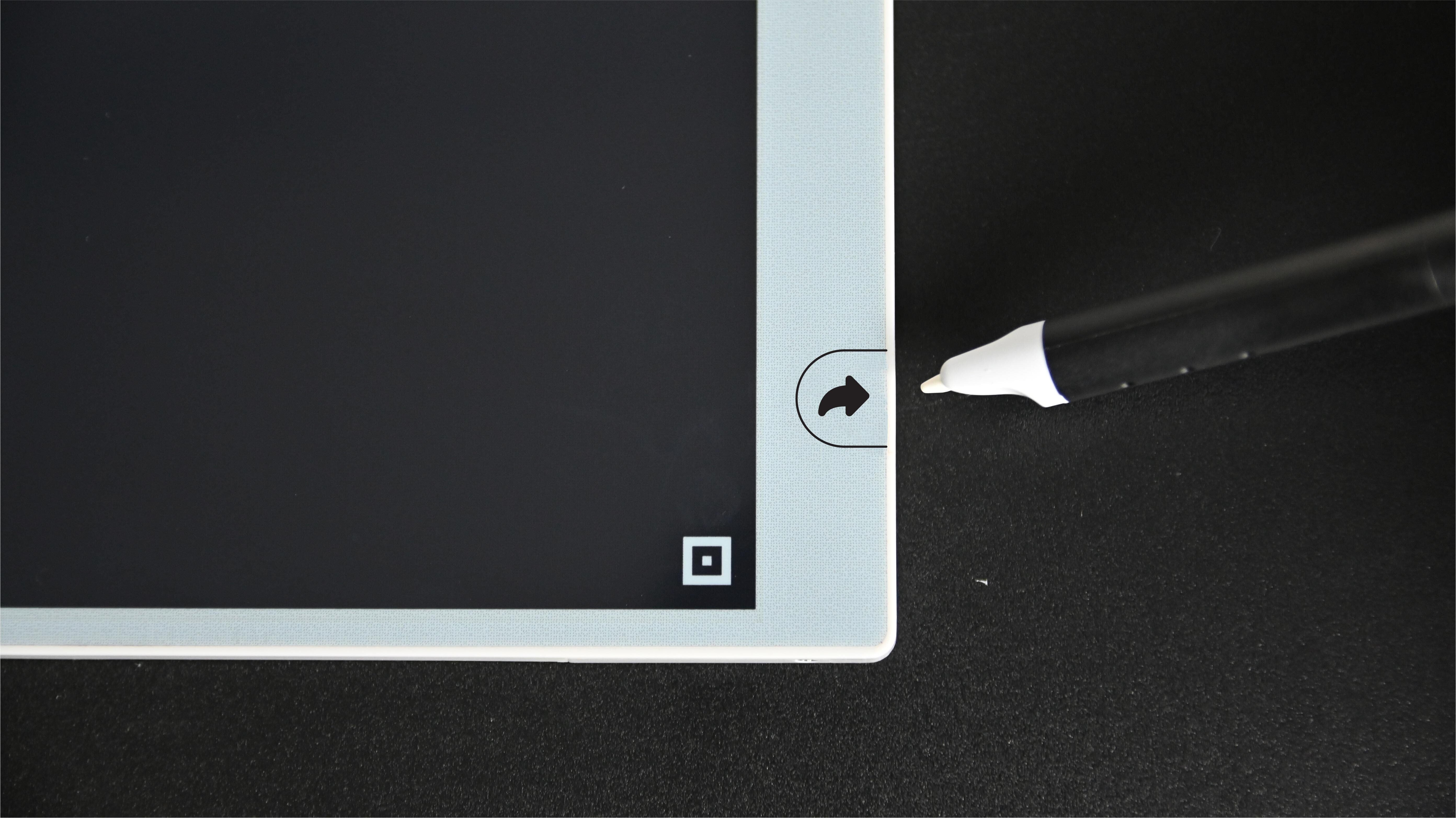 Digital smart notebook with stylus on a black background